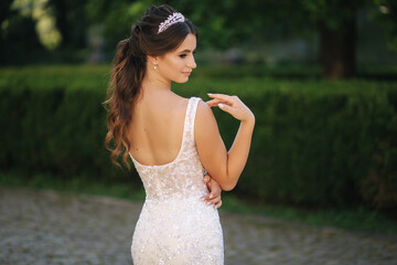 Naklejka premium Portrait of young bride in white wedding dress outdoors. Fashion makeup