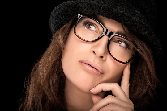 Beautiful pensive woman in stylish glasses. Eyewear and ophthalmology concept