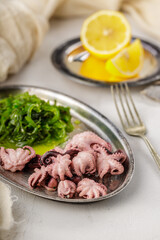 Traditional asian food. Delicious boiled octopus with fresh wakame salad.