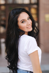 Portrait of beautiful young brunette woman in white t-shirt. Beautiful makeup