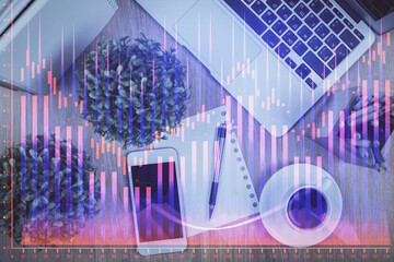 Multi exposure of financial chart hologram over desktop with phone. Top view. Mobile trade platform concept.