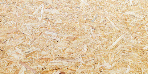 OSB texture of the material - recycled compressed wood chips plate, plywood texture, close-up