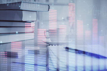 Double exposure of financial chart drawing and desktop with coffee and items on table background. Concept of forex market trading