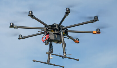 Big black homemade eight motor hexacopter on sky background.