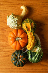 Pumpkins and gourds on a wooden surface