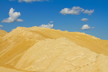 Dump of an abandoned sand pit, sand against the sky, background