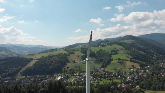 Running wind turbine in Beskids Mountains near village Rytro, Poland