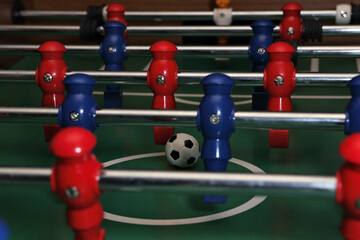Foosball field level with red and blue players and ball