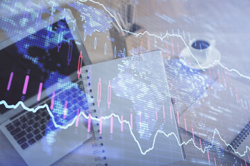Double exposure of businesswoman hands typing on computer and forex chart hologram drawing. Financial analysis concept.