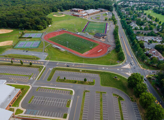 Aerial view of empty stadium with basketball field and training ground in school during Covid-19 pandemic
