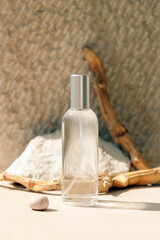 Bottle of natural skin care product, front view. Beige stone background