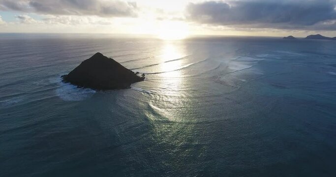 Wide aerial, tropical island at sunset