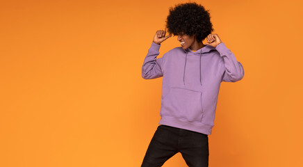 Afro man dancing and smiling.