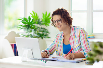 Online remote learning. Teacher with computer.