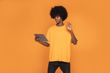 Afro Man looking at Tablet Screen .