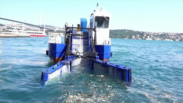 Istanbul, Turkey - May 30, 2016 - Garbage Collecting Boat on Bosphorus Straight Heading Towards Camera