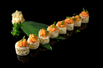 Sushi roll with salmon, avocado, philadelphia cheese on black background. Sushi menu. Japanese food.