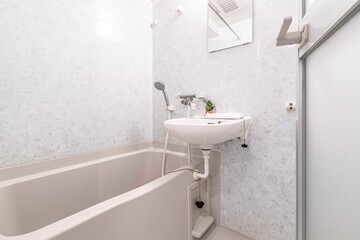 Fototapeta na wymiar Small bathtub and shower in the bathroom at the hotel.