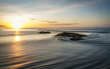 Fototapeta na wymiar Sunrise rocky beach coast scene