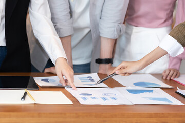 Close up hands of young business woman pointing to sale chart in paper report on table for brainstroming and disscussion in meeting day,Business startup Meeting Concept