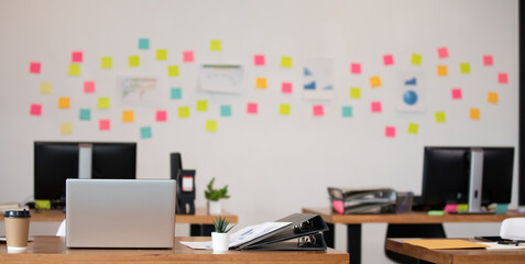 Banner of modern startup office with computer laptop and sticky note on background