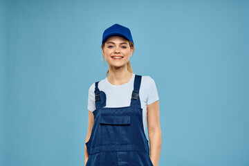 Woman in work uniform blue cap carriage delivery service courier blue background
