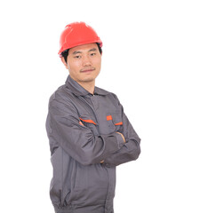 Migrant worker wearing red hard hat standing in front of white background holding hands