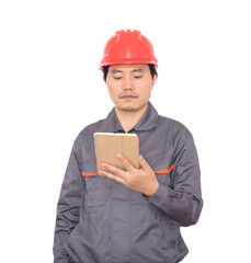 Construction worker with red hard hat holding ipad in hand standing in front of white background