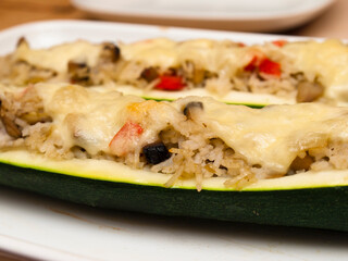 Stuffed zucchini boats with rice, vegetables and cheese