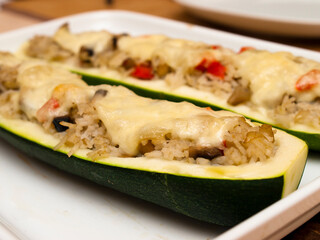Stuffed zucchini boats with rice, vegetables and cheese