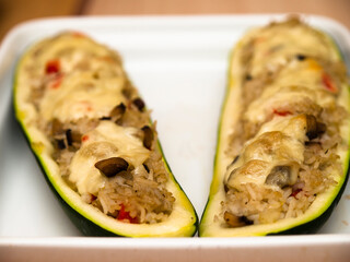 Stuffed zucchini boats with rice, vegetables and cheese