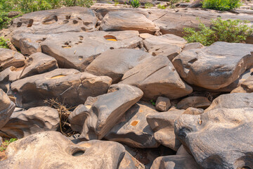 Stone courtyard in nature with bumpy, small and large. erosion by the currents, gravel swirled and eroded in small basins for millions of years forming Potholes at Phetchabun Province Thailand