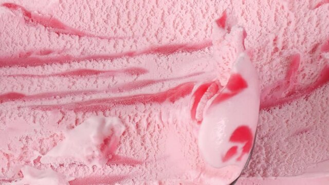 Ice cream Strawberry scooped out from container with a spoon, Closeup Top view Food concept.