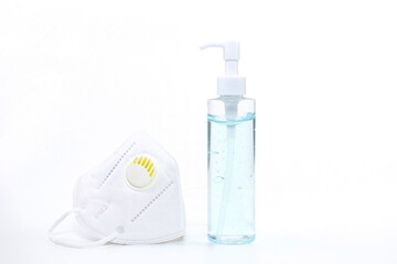 Alcohol gel and medical face mask on white background.