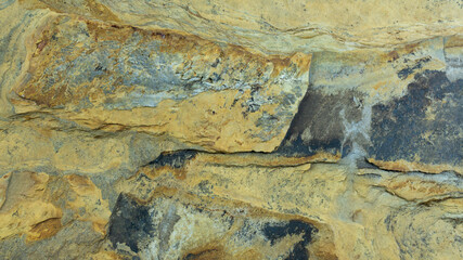 Rust stone wall or grunge, natural pattern, bronze wall, lighting abstract texture background design layout.