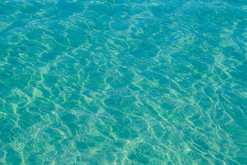Blue pool water with sun reflections