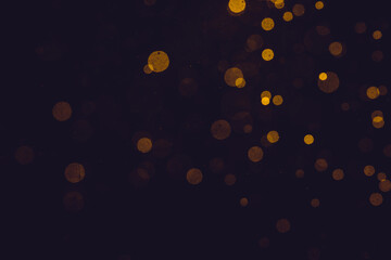 Fantasy gold bokeh sparkle from light on black