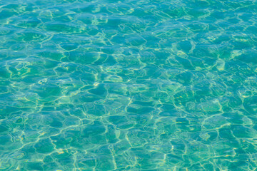 Blue pool water with sun reflections