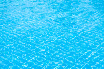 Fototapeta na wymiar Reflections from the water in the blue swimming pool