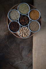 Condiment of indian food Spice garnish background on wood table top view. Seasoning of Asian organic herb cuisine flavour in kitchen board, chilli spicy taste concept