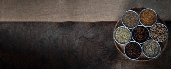 Condiment of indian food Spice garnish background on wood table top view. Seasoning of Asian organic herb cuisine flavour in kitchen board, chilli spicy taste concept