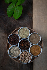 Condiment of indian food Spice garnish background on wood table top view. Seasoning of Asian organic herb cuisine flavour in kitchen board, chilli spicy taste concept