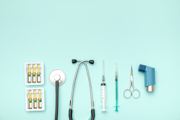 Flat lay of medical tools on colored background