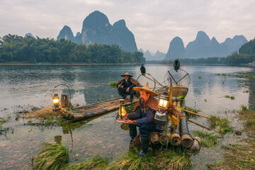 Chinese traditional living habits, images of traveling in Guilin, China, two fishermen relaxing on the Li River.