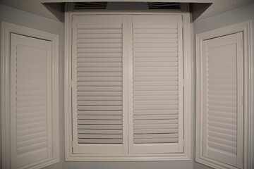 white wooden window with shutters