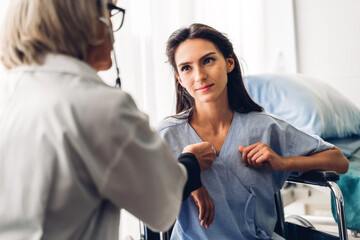 Fototapeta premium Senior woman doctor wearing uniform with stethoscope service help support discussing and consulting talk to sick woman patient about checkup result information in hospital