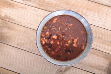 A bowl of prepared laba porridge on wooden background