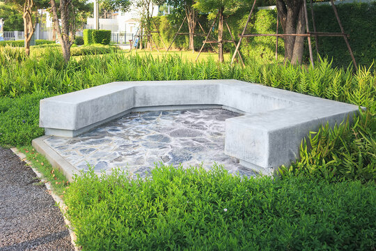 Garden furniture or seating. Construction from concrete,  decorative surface with sandwash and paving stone on floor. For eating a meal, conversation and relax at garden, outdoor, backyard and patio.