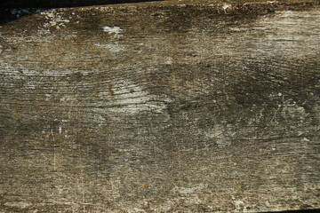 Wooden plank left outside heavy weathered silver grey brown tones - closeup overlay. Fence board, lumber, timber, rouh sawn, background, surface, barnwood