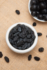 Black raisins or dried black grapes organic dried grapes healthy sweet. prepared by drying the fruit in full sun